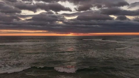Aerial forward hyperlapse of a beautiful beach sunset, flying over the sea .. Stock Footage 339210330