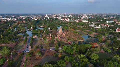 Aerial forward motion to ancient structures of Wat Phra Ram amid water features Stock Footage 312916568