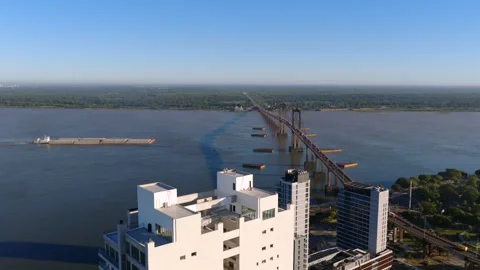 Aerial forward motion over Paraná River showing a cargo ship passing near Stock-Footage 320978280
