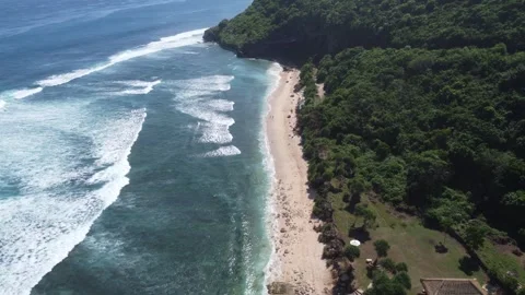 Aerial forward move toward beach entrance, Nyang Nyang Bali Stock Footage 328994037