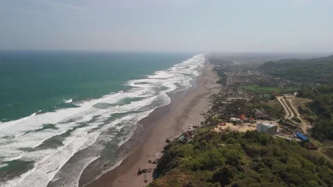 Aerial, forward moving aerial shot of depok beach in Indonesia Stock Footage 293796053