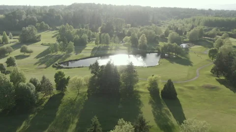 Aerial forward over golf course water trap Stock Footage 154654257