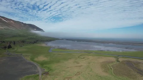 Aerial forward over river estuary as sea fog rolls in, Hellisheidi Eystri Stock Footage 346552103