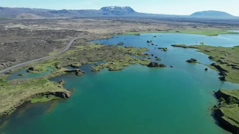 Aerial forward over turquoise lake and lava field at Myvatn, Iceland Stock Footage 346552183