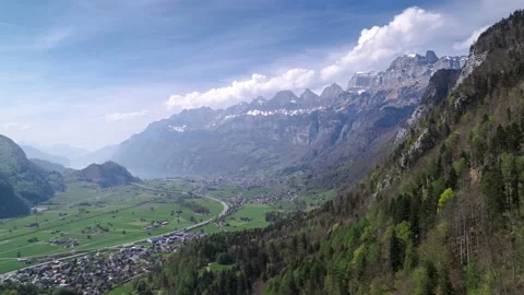 Aerial forward panorama of the mighty mountain range Churfirsten in Switzerland Stock Footage 186924939