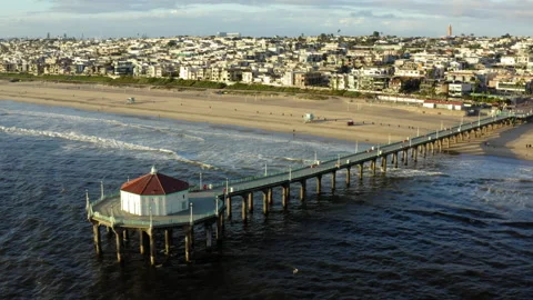 Aerial Forward: Pier on splashing waves in sea against city-CA, Manhattan Beach, Stock Footage 149273808