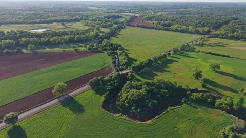 Aerial Forward Push Over Creek Bend And Bridge Lush Late Spring Farmland Stock Footage 333936313