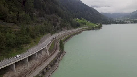 Aerial Forward Scenic View Of Car  On Mountain Road Stockbeeldmateriaal 252151245