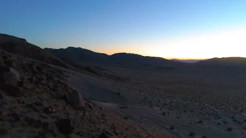 Aerial Forward Shot Of Firework Exploding Over People Camping In Desert Against Video stock 249486647