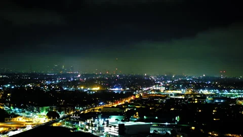 Aerial Forward Shot Of Fireworks Exploding In Illuminated City Under Sky At Stock Footage 255403103