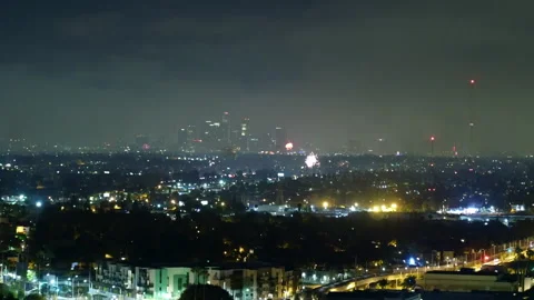 Aerial Forward Shot Of Fireworks Exploding In Modern City Against Sky At Night - Stock Footage 264045742