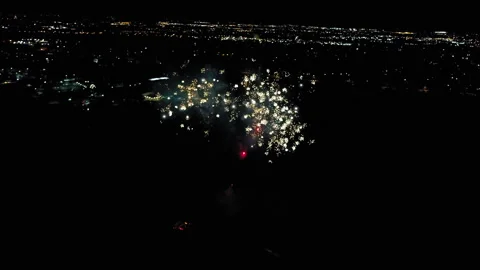 Aerial Forward Shot Of Fireworks Exploring In Residential City Against Clear Sky Stock Footage 272798813