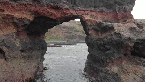 Aerial forward shot flying through an arch in the cliffs by the Australian Stock Footage 126621609