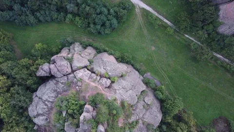 Aerial forward shot. Straight down view above cliff surrounded by grass Stockbeeldmateriaal 138687752