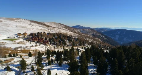 Aerial forward shot of trees and houses on land during winter, scenic view of Stock Footage 128845697
