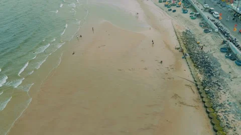 Aerial forward shot of wide Phuoc Hai beach and coastal embankment, Vietnam Stock Footage 334452403