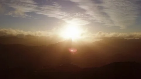 Aerial forward through mist towards a peak at sunset in Canary Islands 4K Video stock 101565788