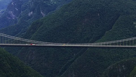 Aerial Forward Tilt Down Mountain Suspension Bridge 4K HLG Stock Footage 345620695