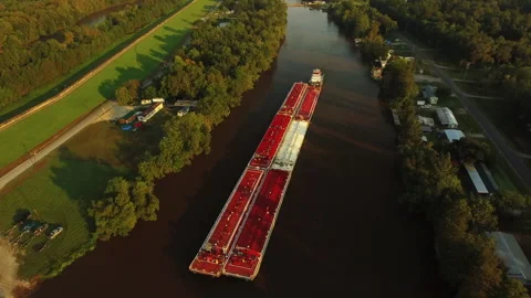 Aerial Forward Tilt Down Shot Of Barges On River Amidst Houses And Trees Against Stock Footage 254043330
