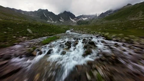 Aerial Forward Tracking Shot Over Mountain Valley Stream Stockbeeldmateriaal 346681700
