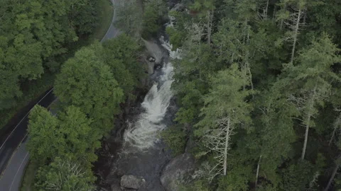 Aerial forward tracking of waterfall and cars on road Stock Footage 137278076