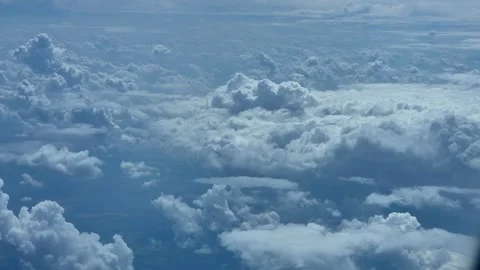Aerial forward view of fluffy white clouds above blue horizon video Stock Footage 340191437