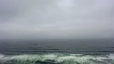 Aerial Forward: Waves splashing in sea against cloudy sky - Cannon Beach, Oregon Stock Footage 149732467