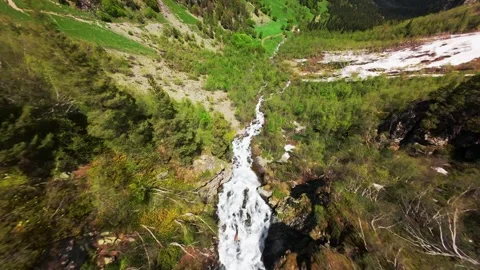 Aerial FPV dive over cascading river through lush green valley landscape Stock Footage 340957355