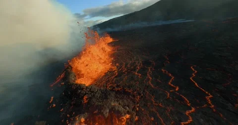 Aerial FPV dive through exploding magma calderas, sunset in Iceland - slow Stock Footage 217353837