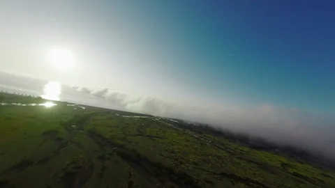 Aerial FPV Drone Exiting Cloud Revealing Mountains Stock Footage 306316248