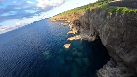 Aerial FPV drone view flying above sea cliffs at sunset in Okinawa, Japan Video stock 331728626
