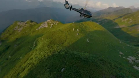 Aerial fpv drone view of helicopter in mountains Stock Footage 330077742