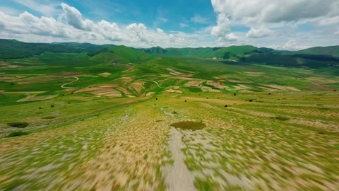 Aerial FPV Flight Over Rolling Hills and Morning Mist in Umbria Stock Footage 305799998
