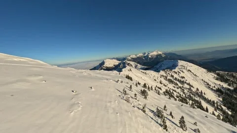 Aerial FPV View: Soaring High Above a Vast, Frozen Winter Mountain Range Stock Footage 321150016