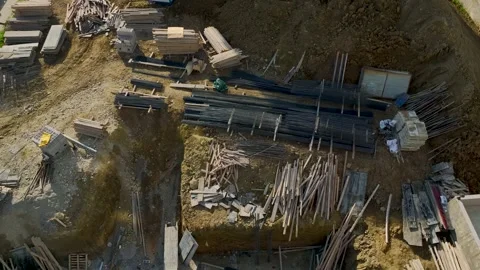 Aerial frame of a foundation pit filled with stacked building elements and Stock Footage 343117593