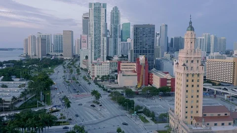 Aerial: Freedom Tower in Downtown Miami & morning traffic along the waterfront Stock Footage
