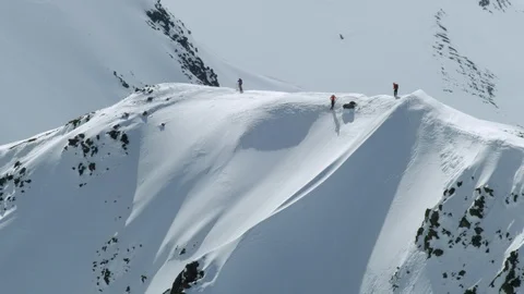 Aerial of freeride skier freeriding down from snowy ridge, Iceland Stock Footage 124226936