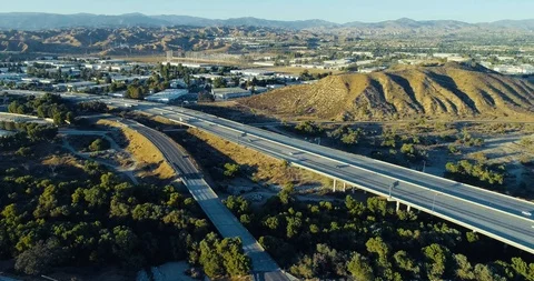 Aerial of freeway with traffic pull back Stock Footage 96031483