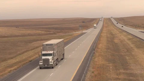 AERIAL Freight container semi trucks transporting goods driving on rural highway Stock Footage 77009178