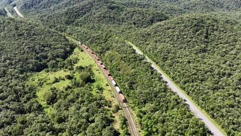 Aerial Freight Train and Highway Through Forested Hills Vídeos de archivo 344688714