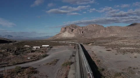 Aerial of a freight train heading through a mountain pass Stock Footage 256713170