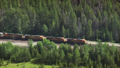 Aerial of freight train running on track lush green rolling hills, Flight Stock Footage 109455996