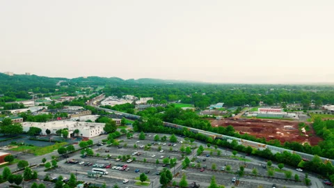 Aerial freight train traveling through Birmingham Alabama suburbs Stock Footage 337543470