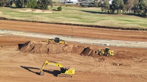 Aerial of front end loader and grader working near parked excavator at buil.. Stock Footage 278340139