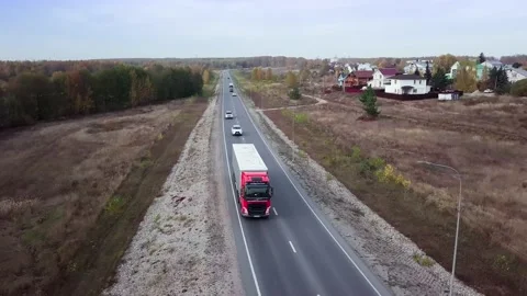 Aerial front side view of semi truck moving along a highway with cargo trailer. Stock-Footage 196235979