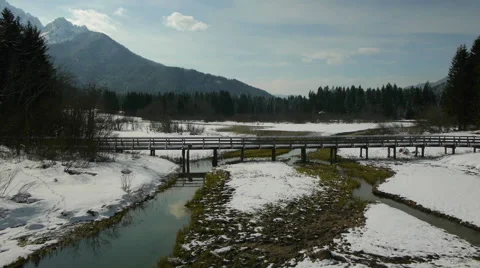 Aerial front view of snowy bridge and spring Stock-Footage 44882905