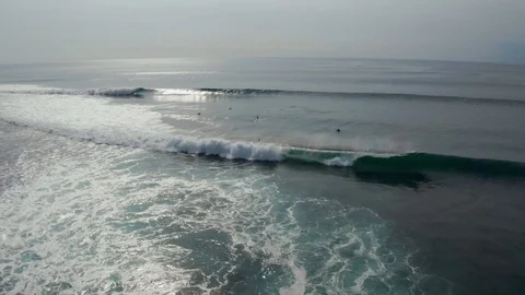 Aerial front view of surfer riding wave in Uluwatu Bali 4K Drone Footage Stock Footage 103222382