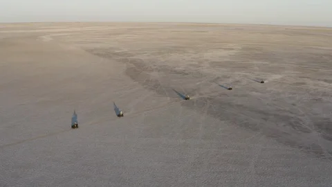 Aerial front view of tourists having fun driving quad bikes in the wide open Stock Footage 107220256