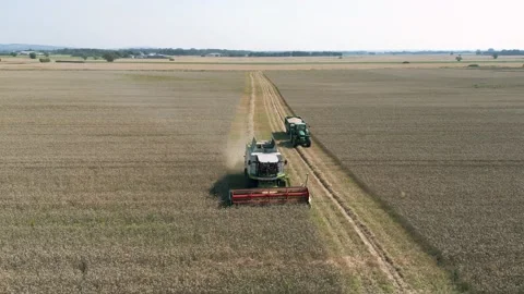 Aerial front view tracking view clip of a combine harvester harvesting wheat Stock Footage 205330503
