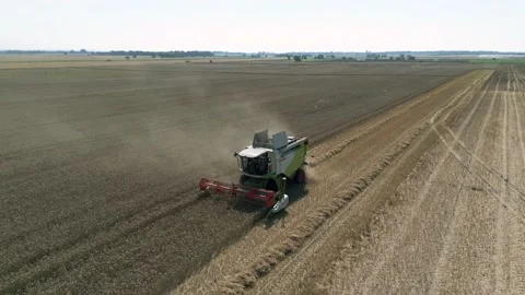 Aerial front view tracking view clip of a combine harvester harvesting wheat Stock Footage 205330561